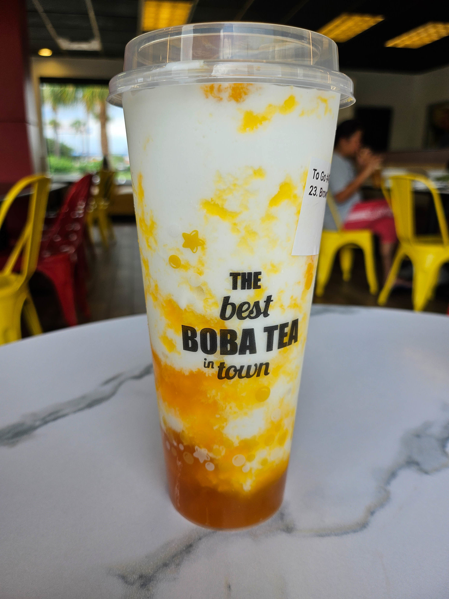 white and brown boba drink